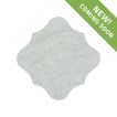 The Angelique Crest Tile in Verde Laguna marble, seen with a tumbled and bush-hammered finish.