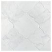 The Angelique Crest + Flower waterjet tile module in Mugla White marble, seen in a tumbled and bush-hammered finish.