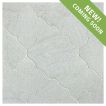 The Angelique Crest + Flower waterjet tile module in Verde Laguna marble, seen in a tumbled and bush-hammered finish.