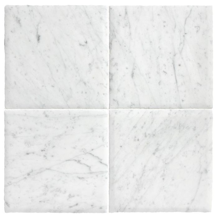Four tiles of the Chateau Lyon 8" x 8" tiles in Italian Carrara Light Select with a hand burnished finish.