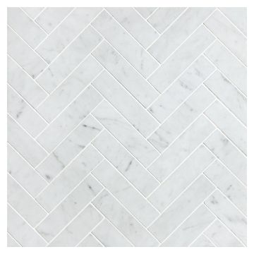 A field of the 1" x 4" Herringbone Grande mosaic in honed Italian Carrara Light Select marble. A field of the 1" x 4" Herringbone Grande mosaic in honed Italian Carrara Light Select marble.