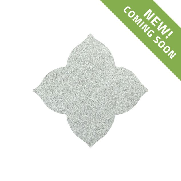 The Angelique waterjet Flower tile in Verde Laguna marble, seen in a tumbled and bush-hammered finish.