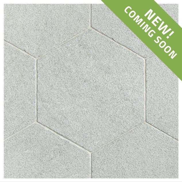 The Timeless Tumbled 10-1/2" Hexagon tile in Verde Laguna marble, seen with a tumbled and bush-hammered finish.