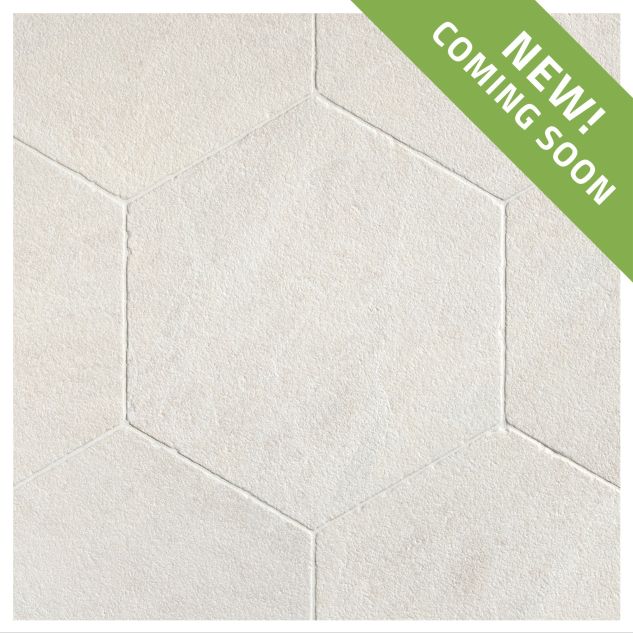 The Timeless Tumbled 10-1/2" Hexagon tile in Vanilla Ice marble, seen with a tumbled and bush-hammered finish.
